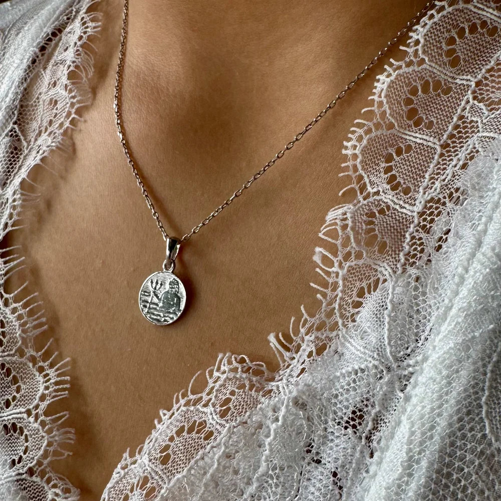 Classic silver pendant necklace with intricate design, perfect for women who appreciate minimalist, vintage style.
