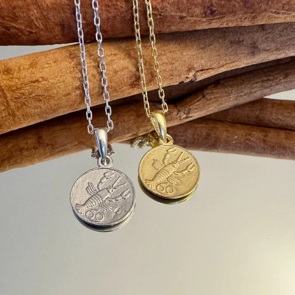 Silver and gold lobster pendant necklaces perfect for trendy women; stylish and unique for casual or special occasions.