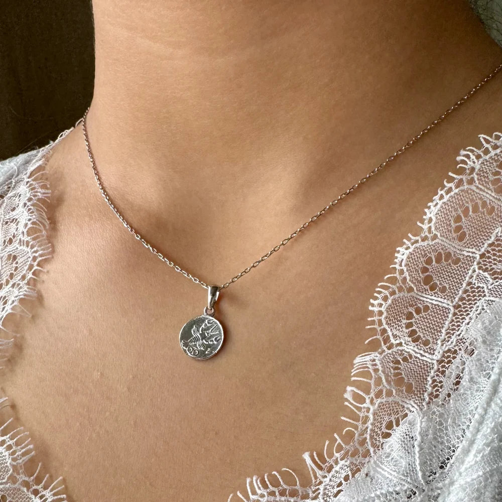 Silver pendant necklace with intricate design, perfect for women seeking a minimalist, elegant accessory for any occasion.