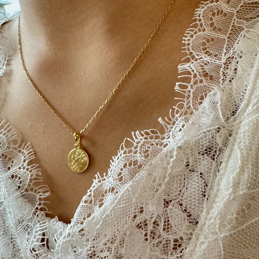 Gold coin pendant necklace on a model, perfect for women seeking a classic, elegant touch for any occasion.