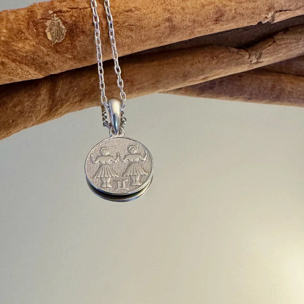 Sterling silver pendant featuring intricately designed twins, perfect for women seeking a vintage look.
