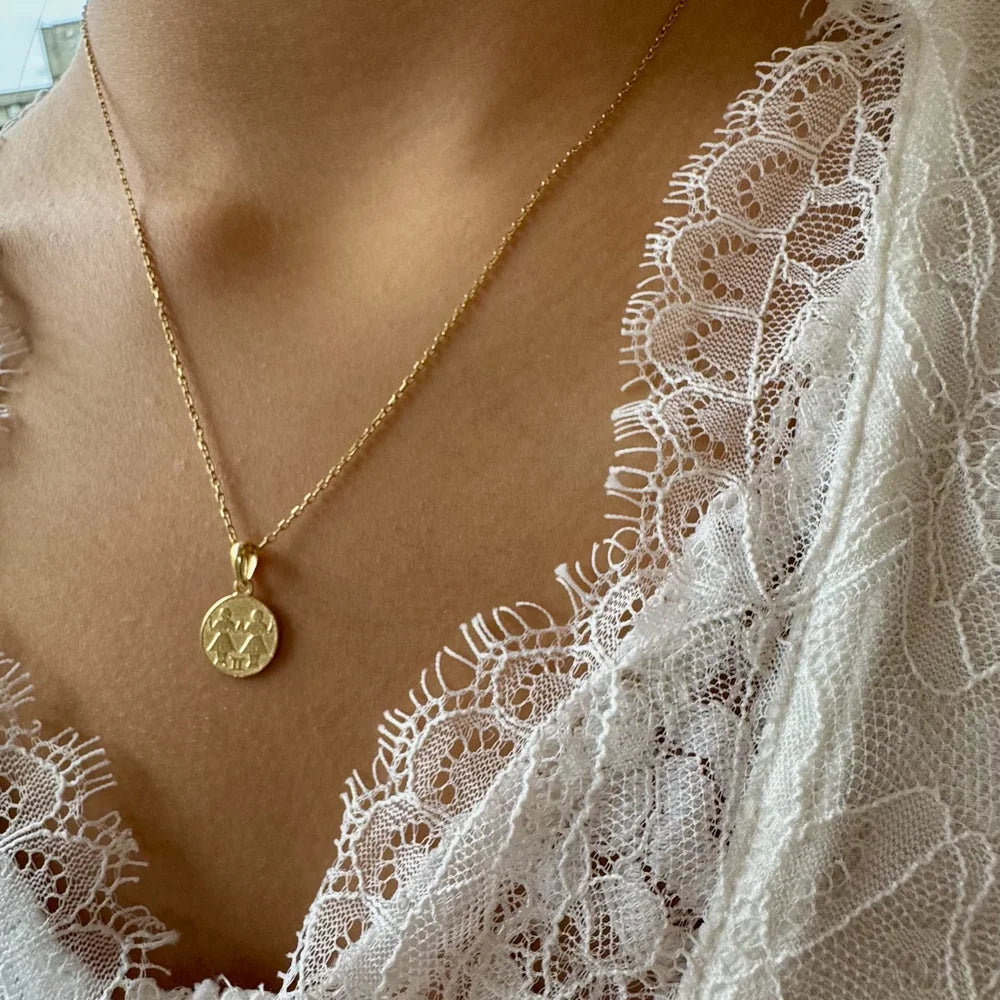 Delicate gold pendant necklace featuring a minimalist design, perfect for women seeking timeless elegance.