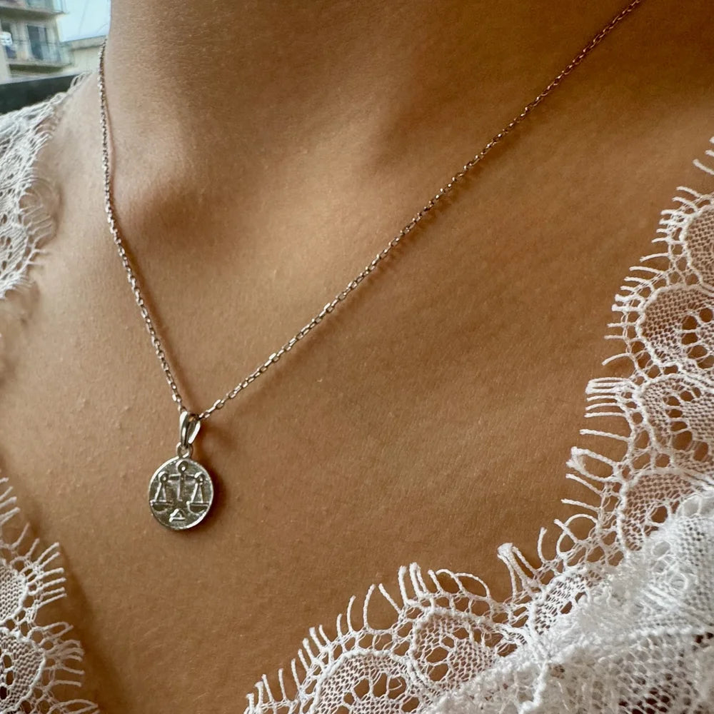 Stylish silver pendant necklace featuring a scales design, perfect for women seeking minimalist or classic jewelry.