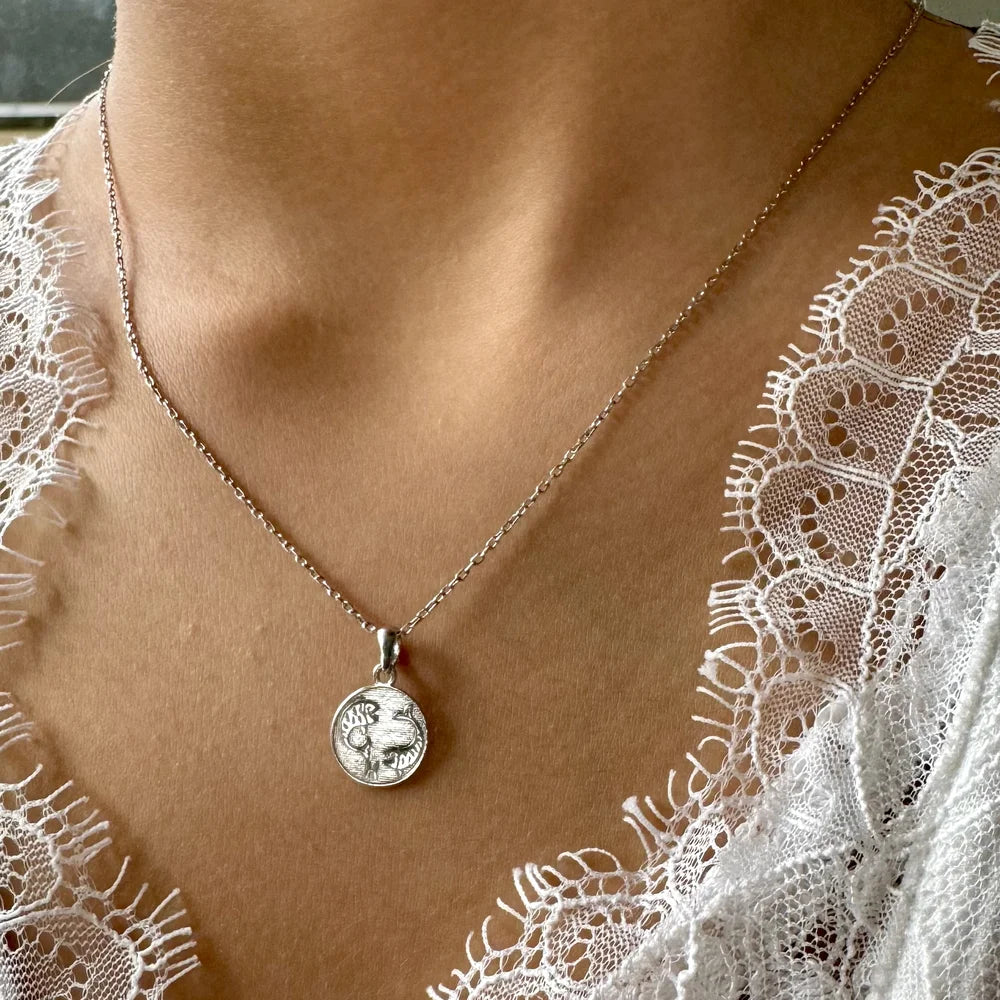Sterling silver pendant necklace featuring a vintage-style coin design, perfect for women seeking minimalist elegance.