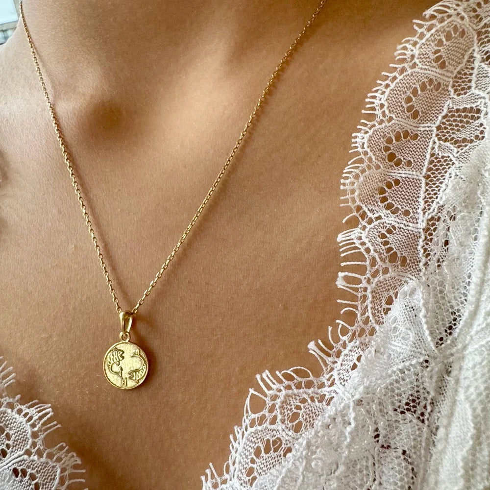 Delicate gold necklace with a vintage coin pendant, perfect for women seeking a chic, minimalist accessory.