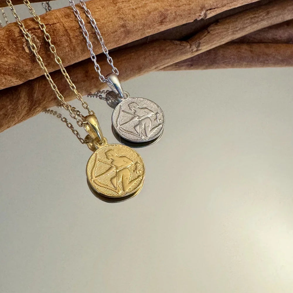 Gold and silver vintage-style pendants featuring intricate designs, perfect for men or women. Ideal for casual or formal occasions.