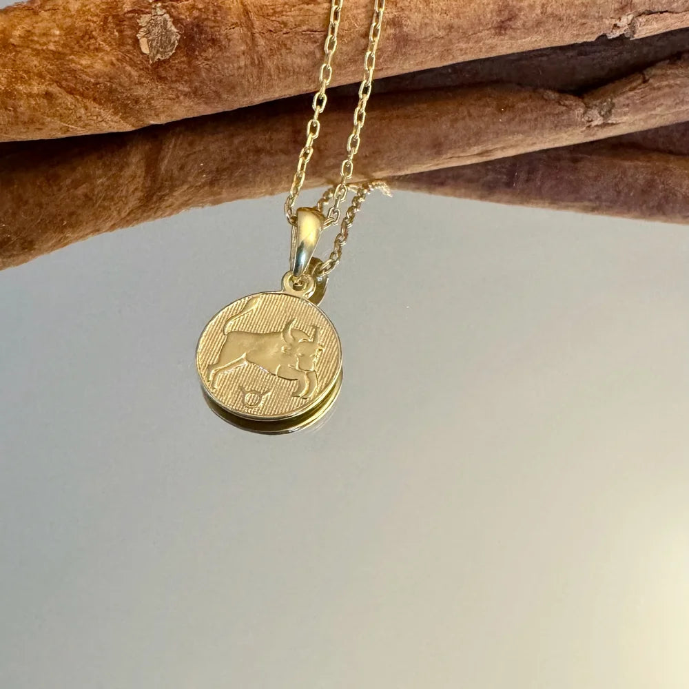Gold dog charm necklace on a delicate chain, perfect for animal lovers seeking a unique, minimalist accessory.