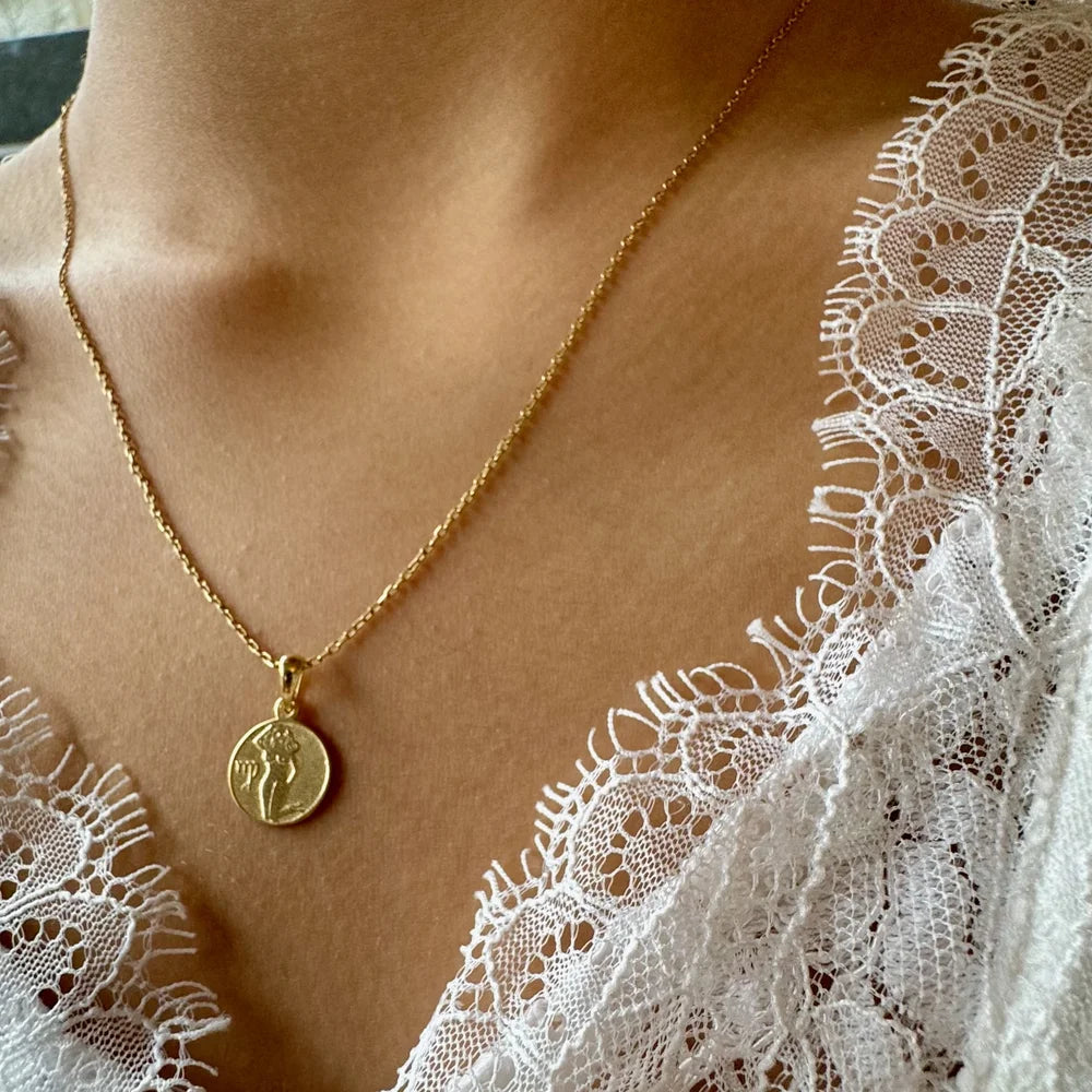Gold pendant necklace with intricate design, perfect for women seeking a minimalist, elegant touch for any occasion.