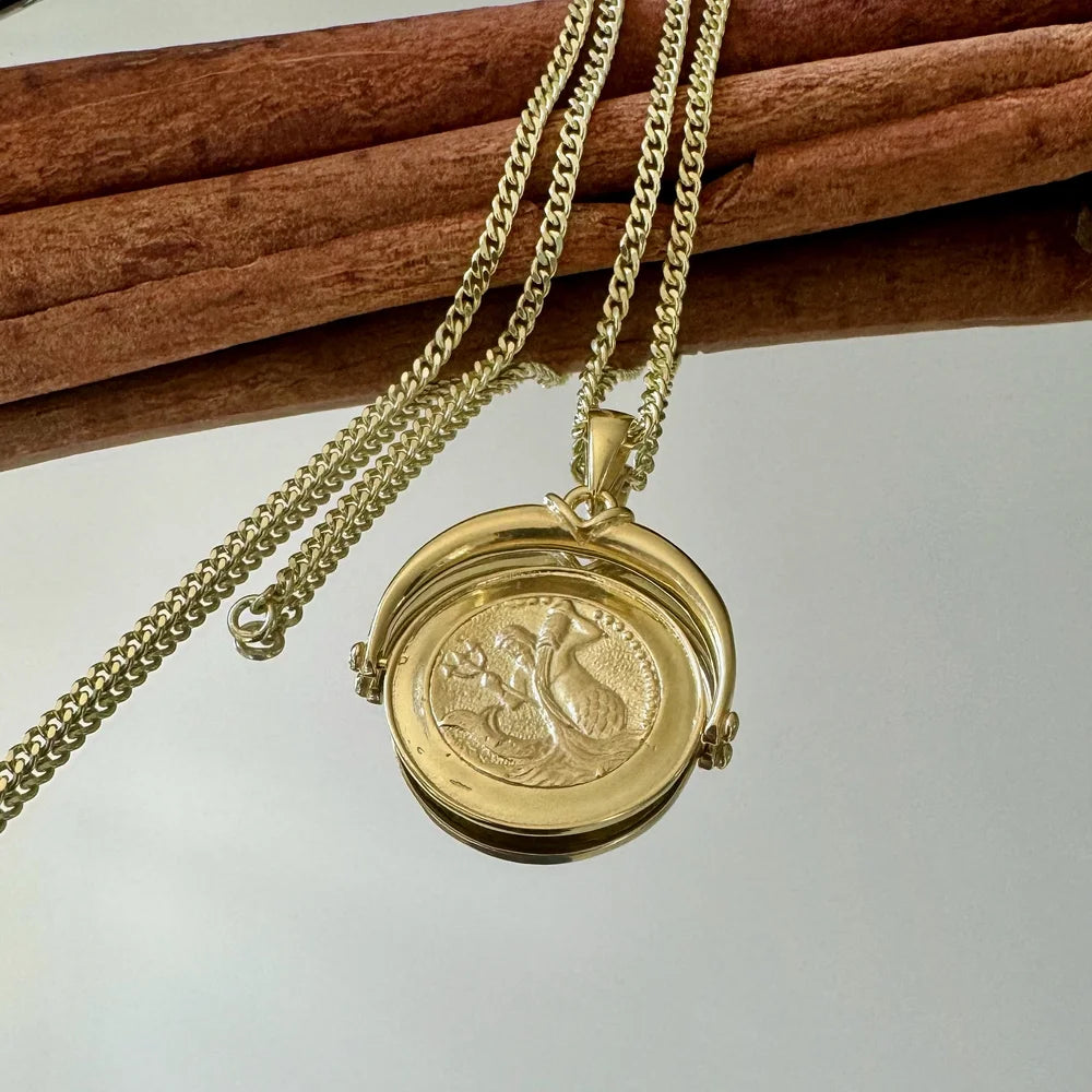 Elegant gold locket necklace with intricate design, perfect for women seeking vintage style for special occasions.