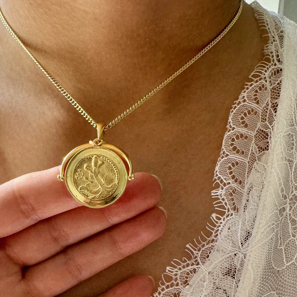 Elegant gold pendant necklace with a vintage design, perfect for women seeking unique, timeless jewelry for special occasions.