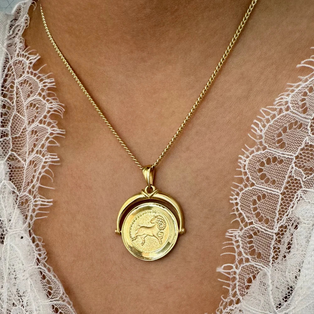 Gold zodiac pendant necklace featuring a classic design, perfect for women who love unique, personalized jewelry.