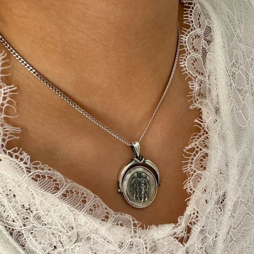 Sterling silver locket necklace featuring vintage detailing, perfect for women seeking a timeless accessory.