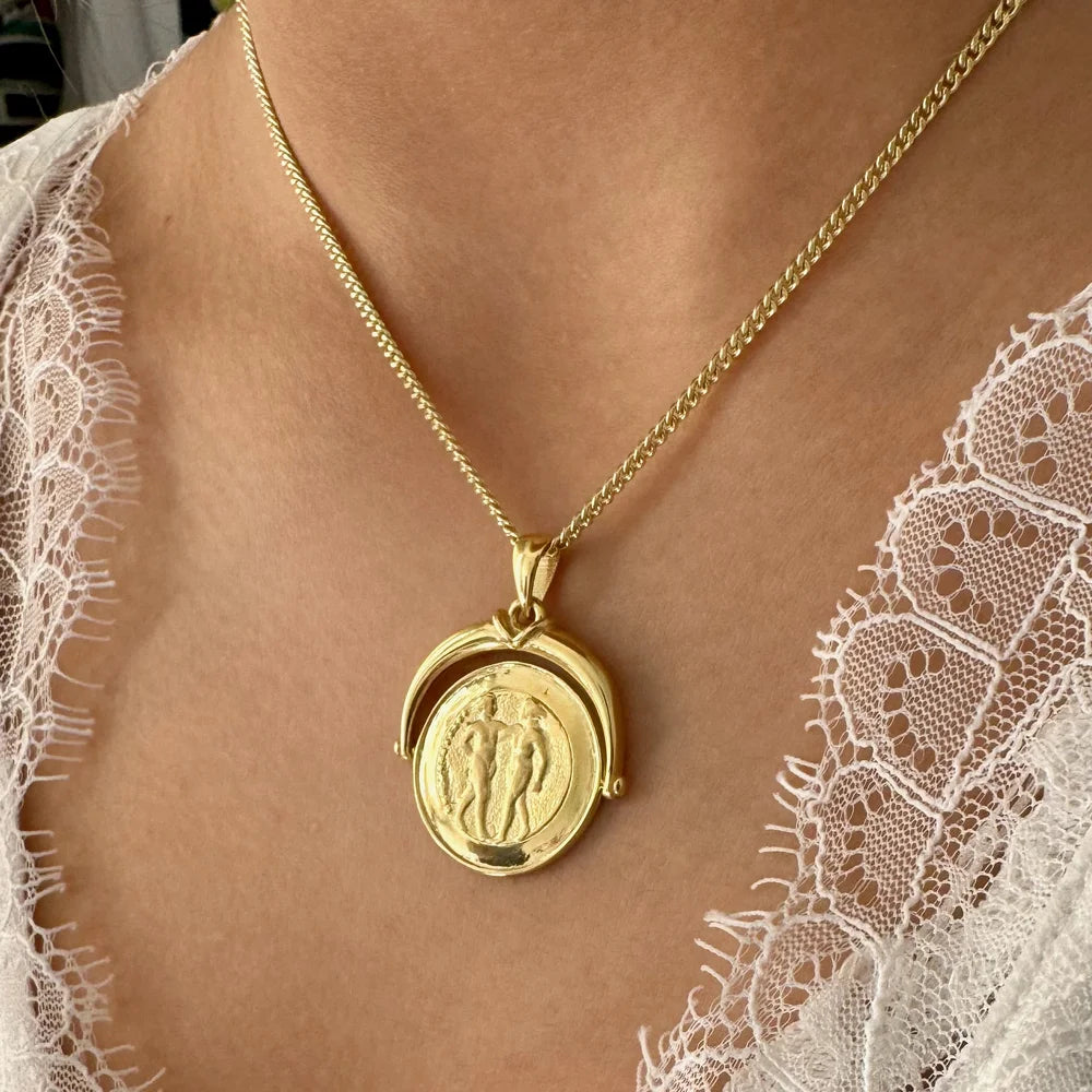 Gold vintage pendant necklace with intricate couple design, perfect for women seeking classic elegance.