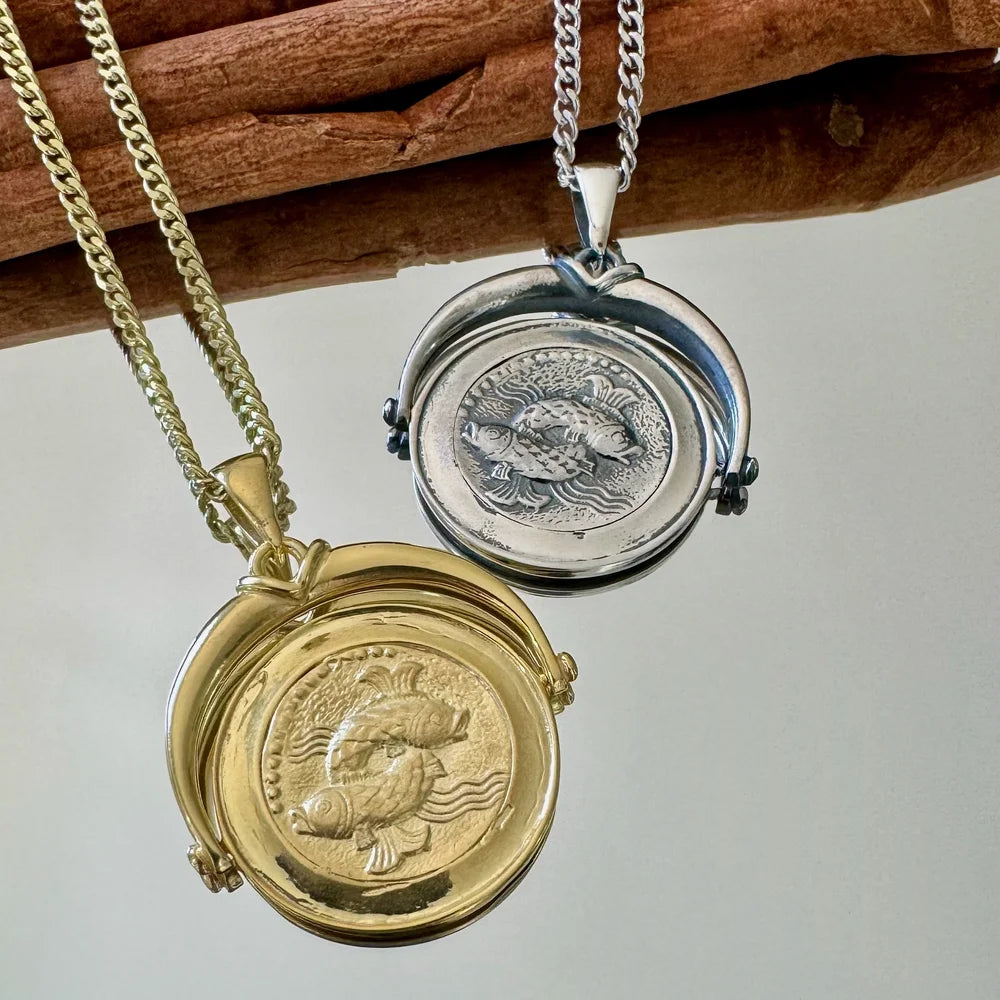 Gold and silver fish pendant necklaces perfect for unisex wear, ideal for casual or bohemian styles.