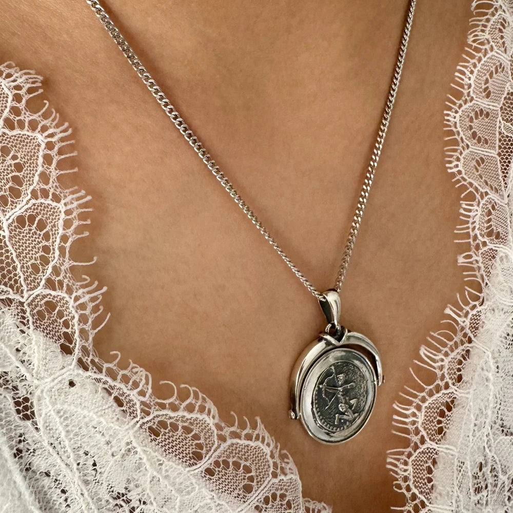 Silver vintage locket necklace with intricate design, perfect for women seeking classic elegance for any occasion.
