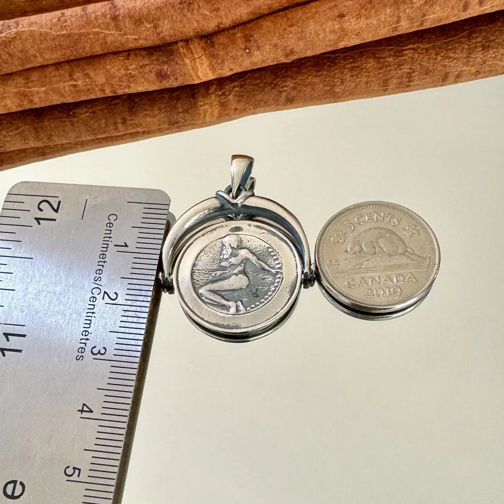 Sterling silver vintage locket featuring an intricate design, ideal for women seeking unique jewelry for special occasions.