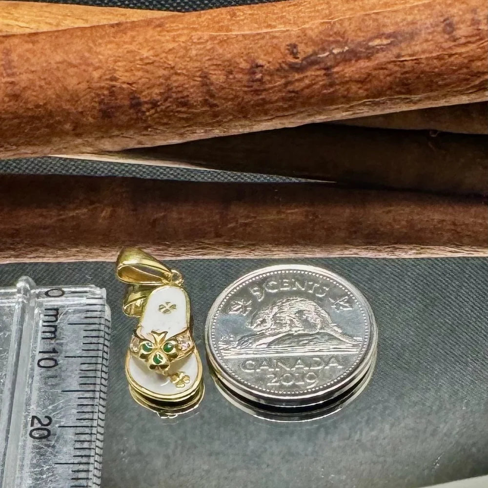 Gleaming gold sandal charm with green gemstones, perfect for women's trendy jewelry or a unique gift.