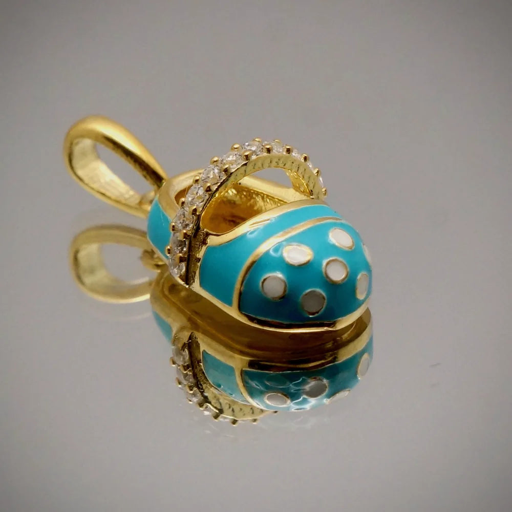 Turquoise and gold charm pendant with crystal accents, perfect for women who love vintage and playful styles.