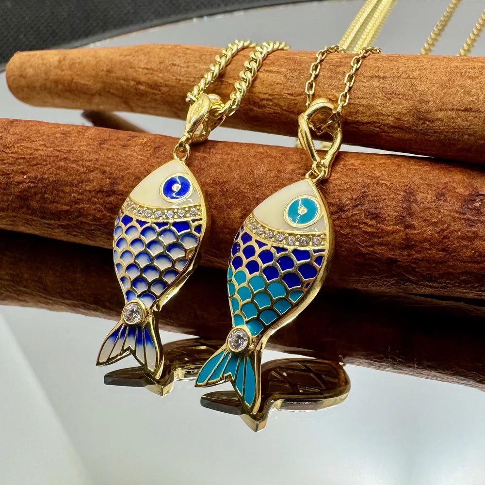 Gold fish pendant necklaces with colorful enamel and sparkling accents, perfect for women seeking a bohemian style.
