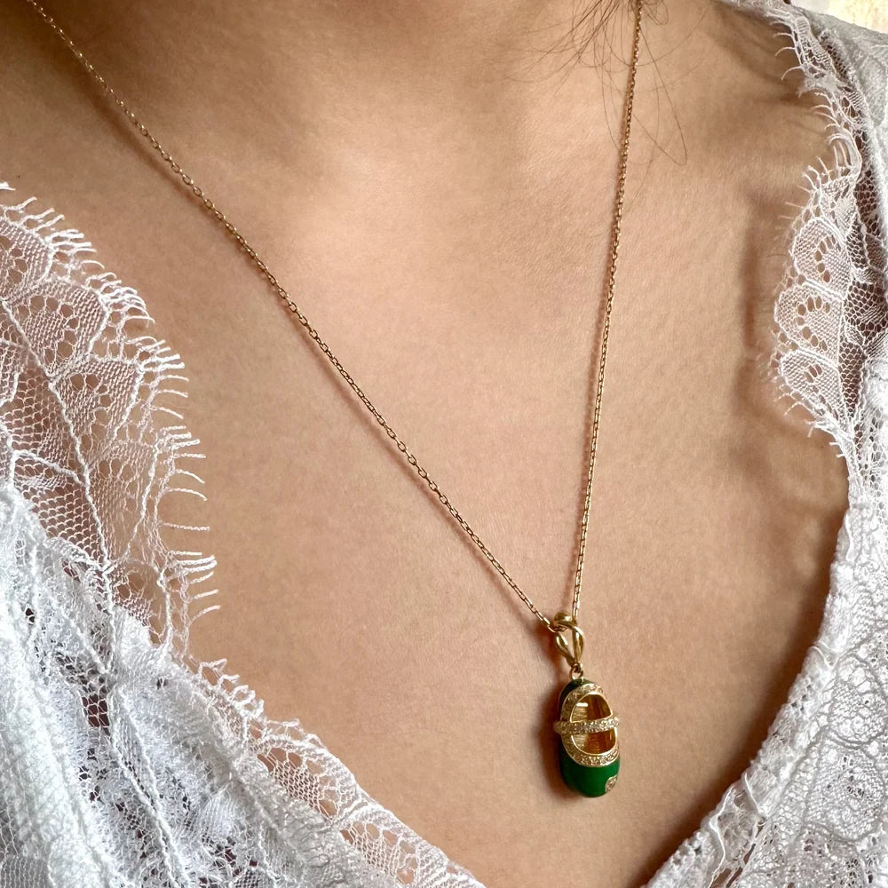Elegant gold pendant necklace featuring a green gemstone, perfect for women seeking vintage-inspired jewelry.