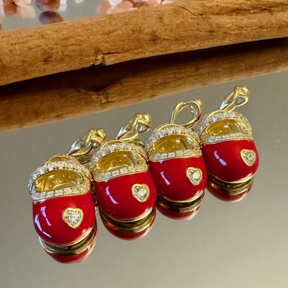 Gold and red enamel slipper charms adorned with sparkling crystals, perfect for women’s trendy jewelry collections.