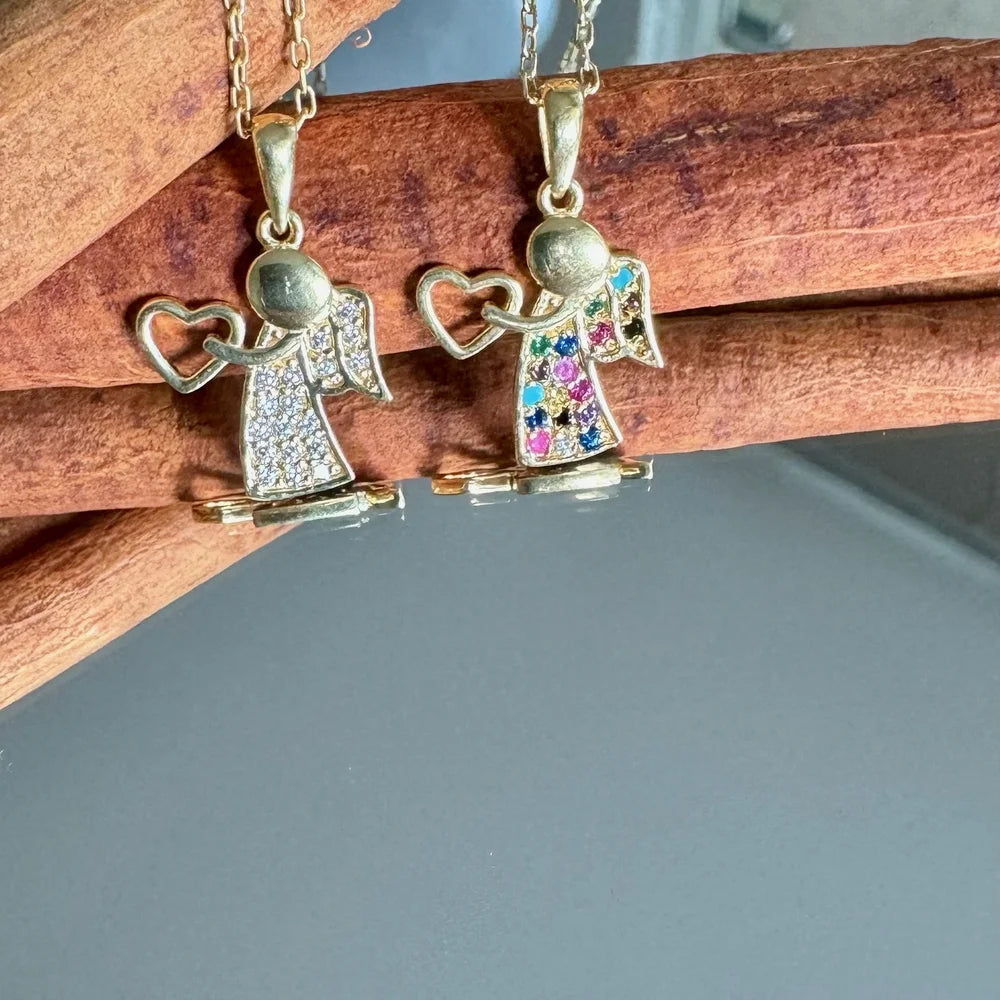 Gold angel pendant necklaces adorned with colorful gemstones, perfect for women who appreciate whimsical vintage jewelry.