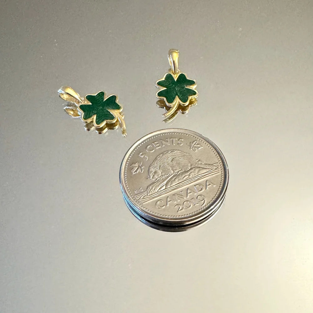 Gold clover leaf earrings adorned with green enamel, perfect for women seeking a classic, lucky charm style.