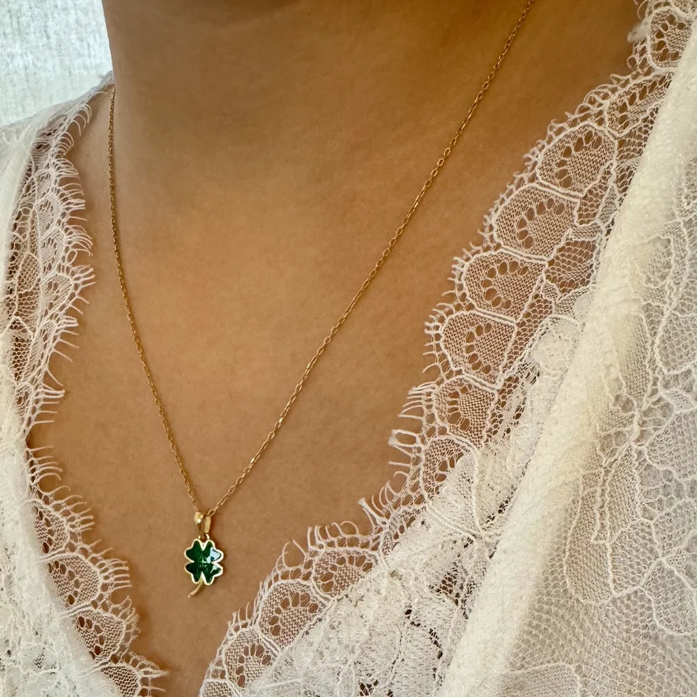 Delicate gold necklace featuring a green gemstone clover pendant, perfect for women who love minimalist jewelry.