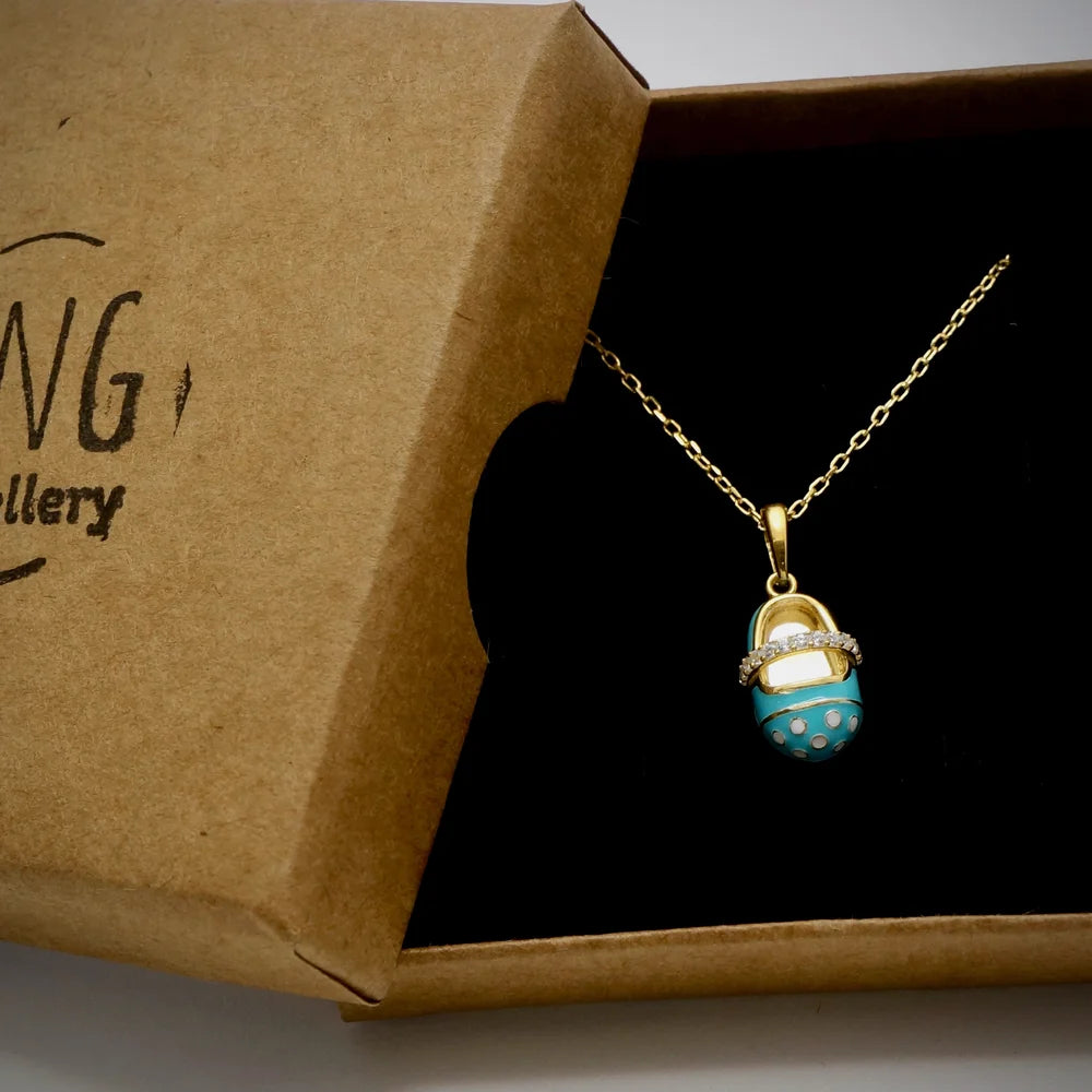 Gold-tone necklace featuring a whimsical turquoise charm, perfect for women seeking playful vintage style. Ideal for special occasions.