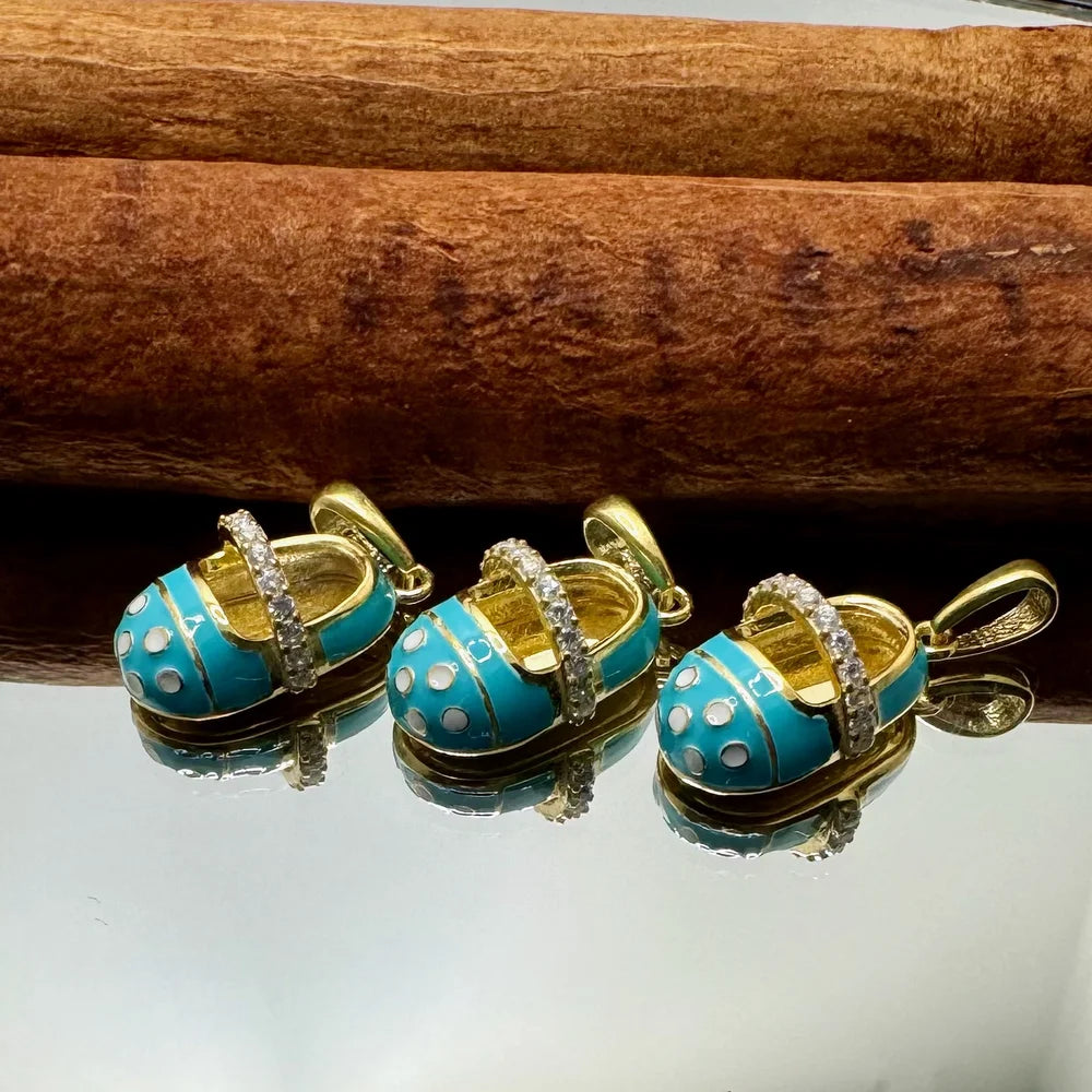 Gold and turquoise enamel baby shoe charms with crystals, perfect for women’s playful or vintage-style jewelry.