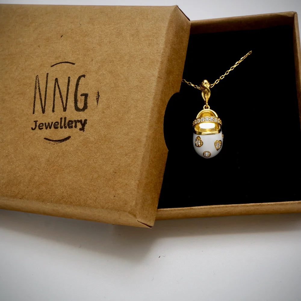 Gold pendant necklace with white enamel and sparkling accents, perfect for women who love vintage, elegant accessories.