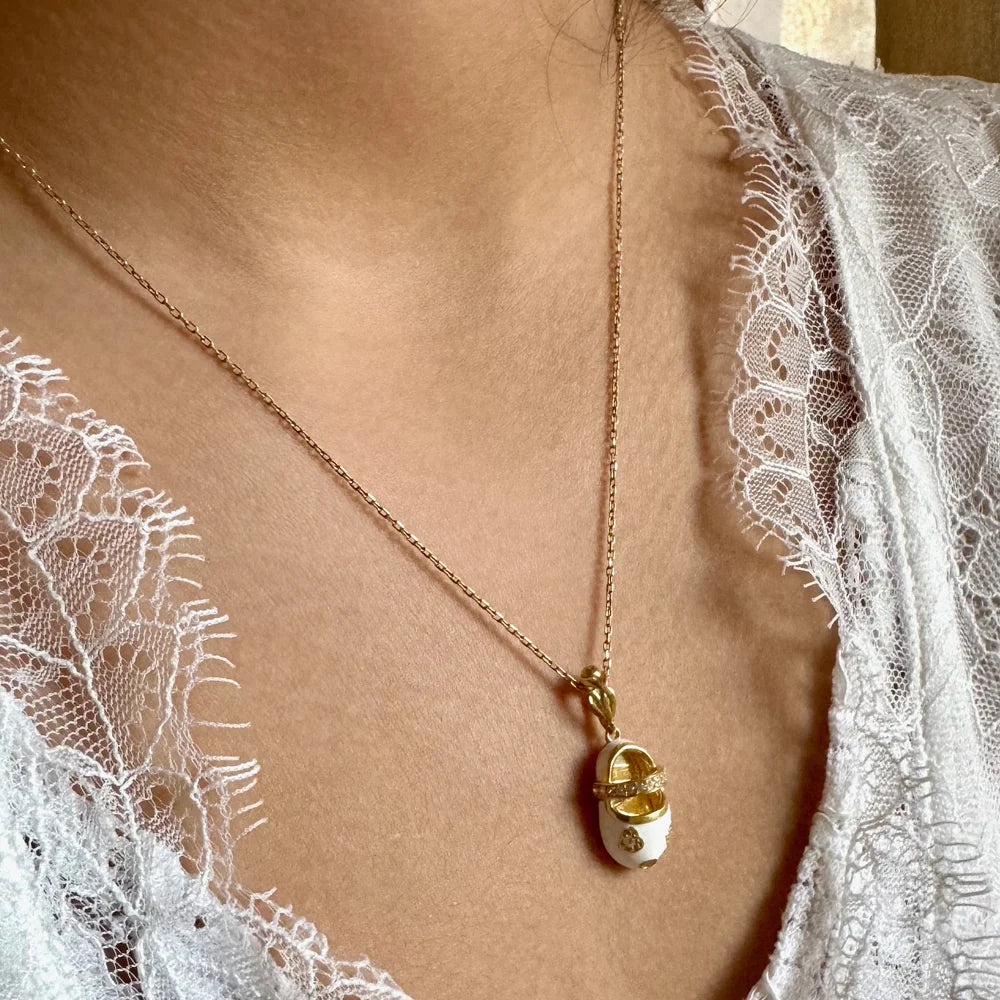 Delicate gold pendant necklace with a charming egg-shaped charm, perfect for women seeking minimalist, chic style.