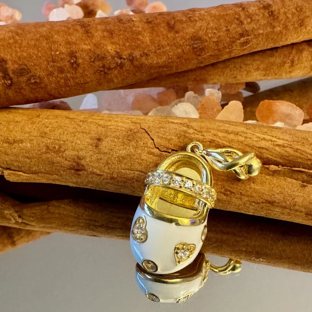 Charming gold and white sneaker charm adorned with crystals, perfect for trendy women and unisex styles.