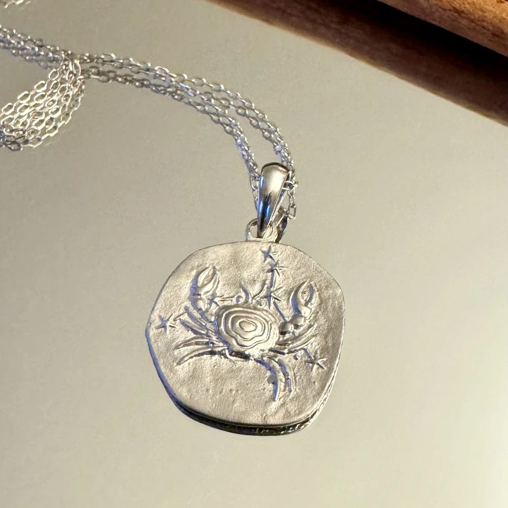Silver crab pendant necklace, perfect for women. Unique ocean-inspired design for casual or beachwear.