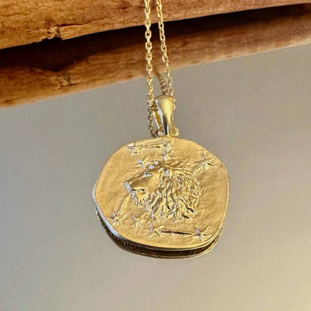 Gold lion pendant necklace with star accents, perfect for women seeking a unique and bold statement piece.