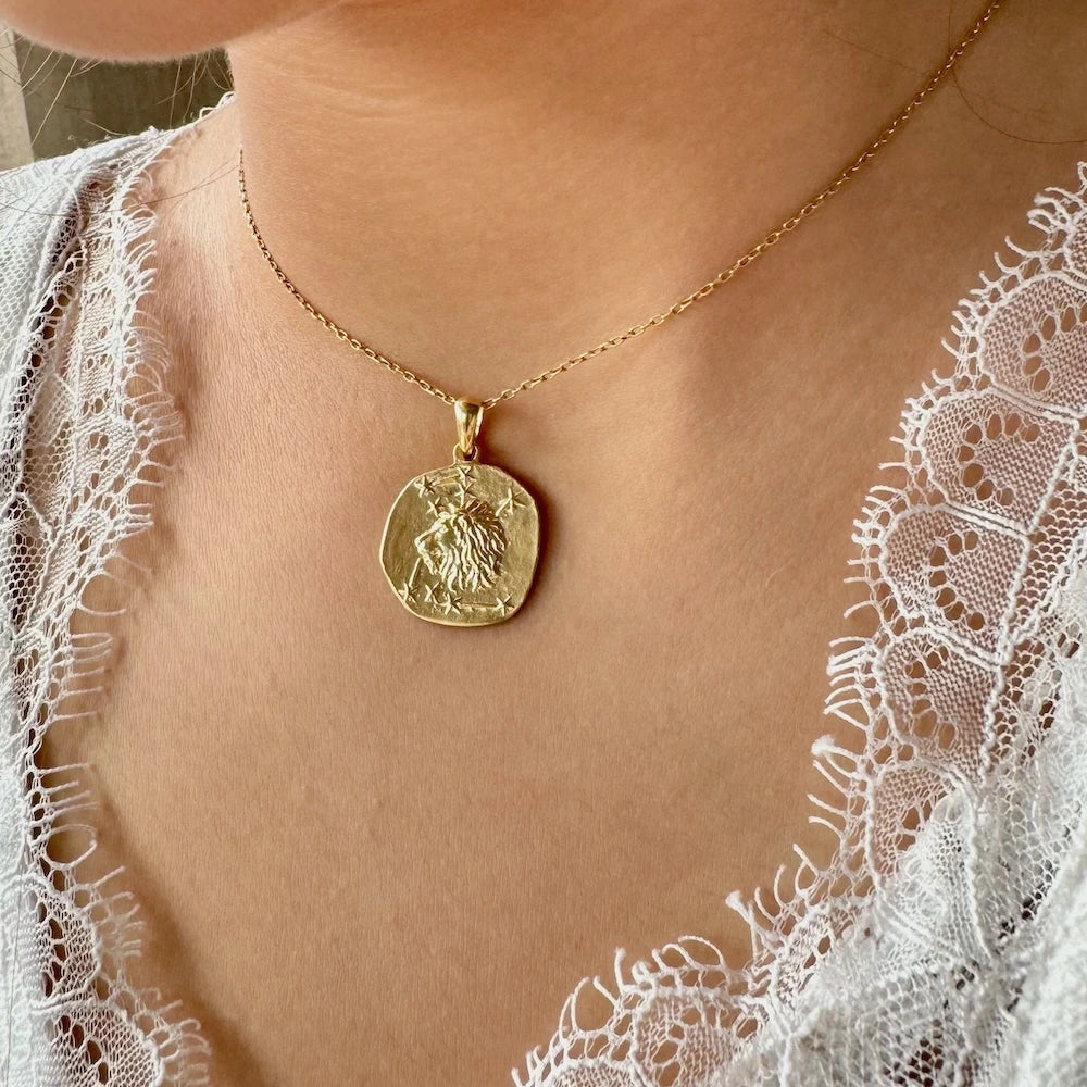 Gold lion pendant necklace on a delicate chain, perfect for women seeking a vintage and artistic jewelry piece.