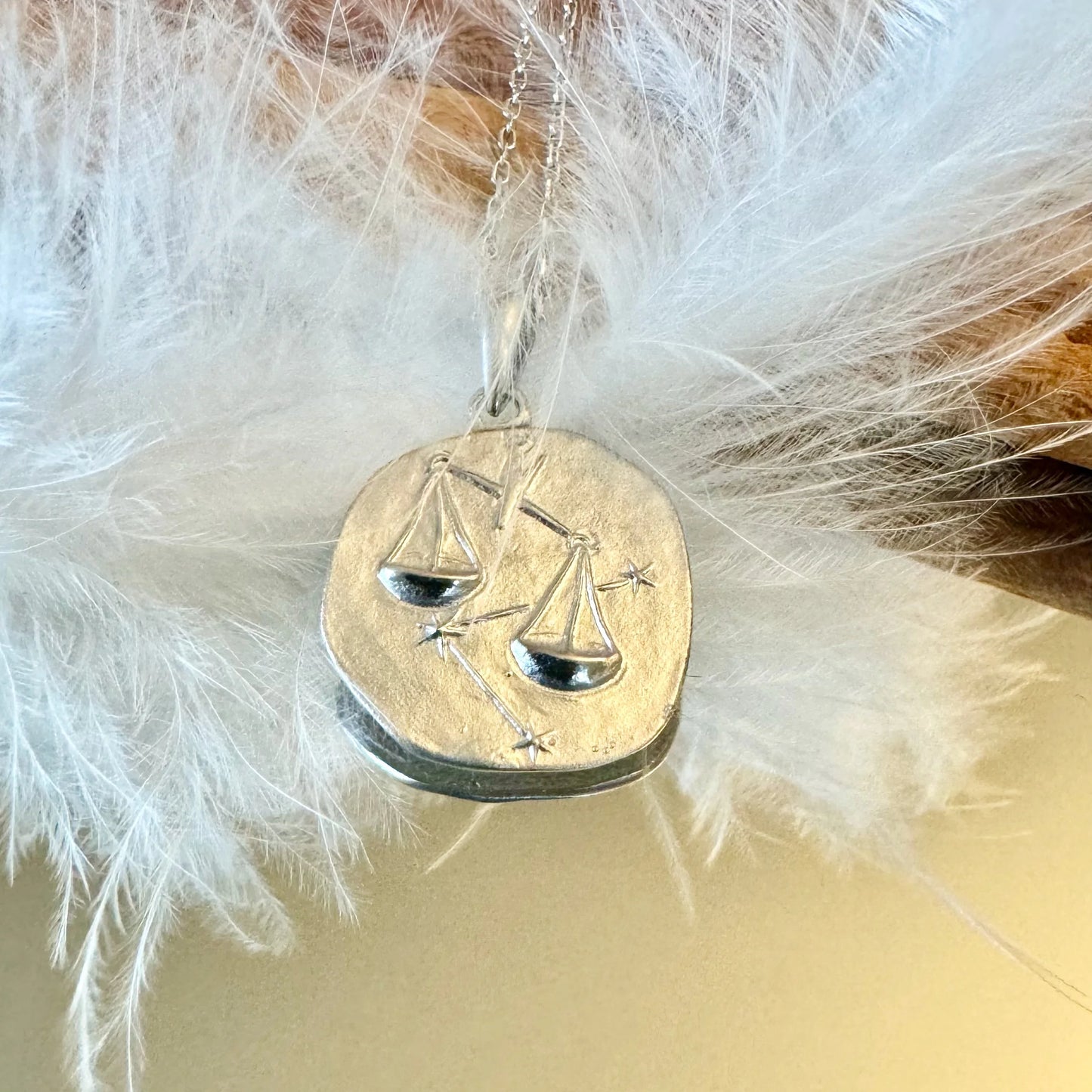 Silver balance scales pendant necklace, perfect for women who appreciate minimalist astrology-themed jewelry.