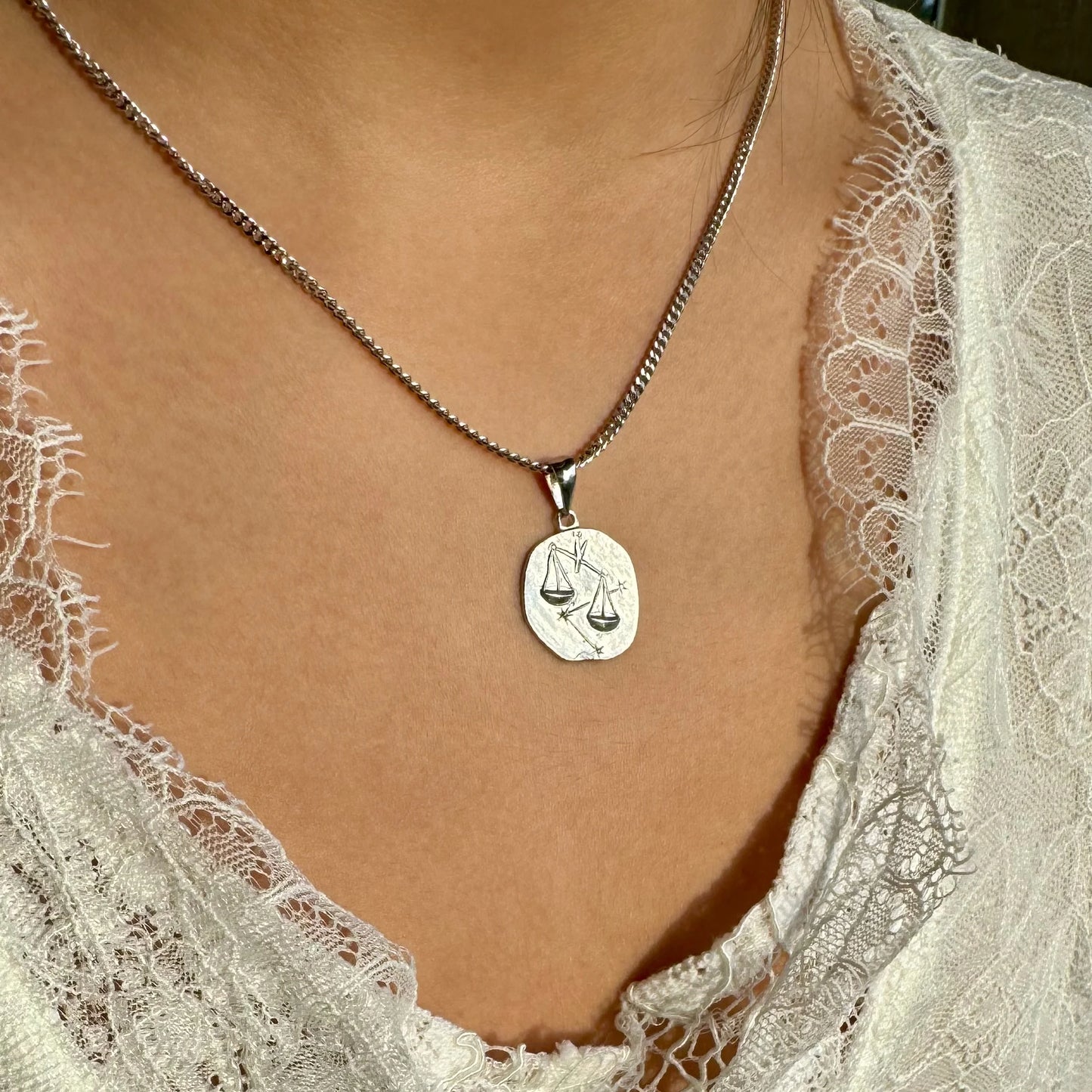 Elegant sterling silver zodiac scales pendant necklace for women, perfect for a minimalist or bohemian style.