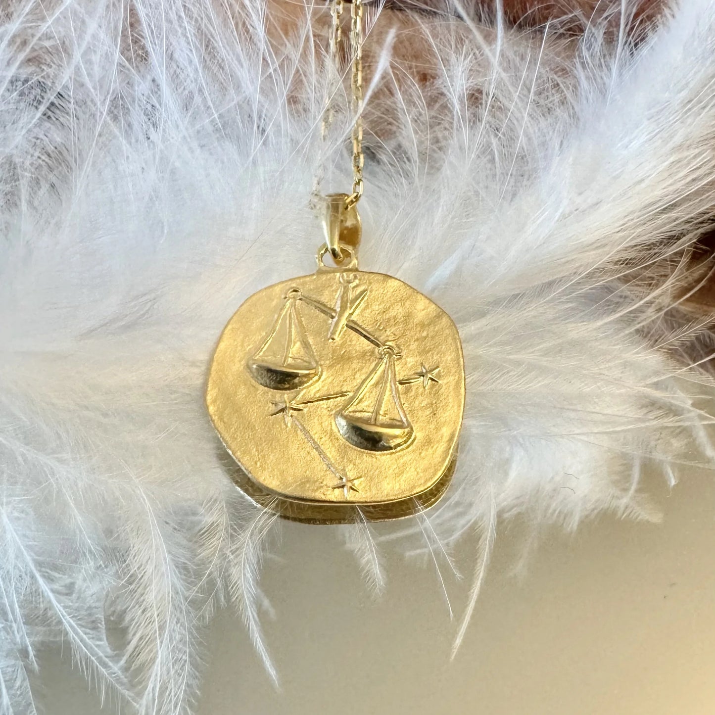 Gold Libra zodiac pendant necklace, perfect for women; vintage-inspired design with balance scales and stars detail.