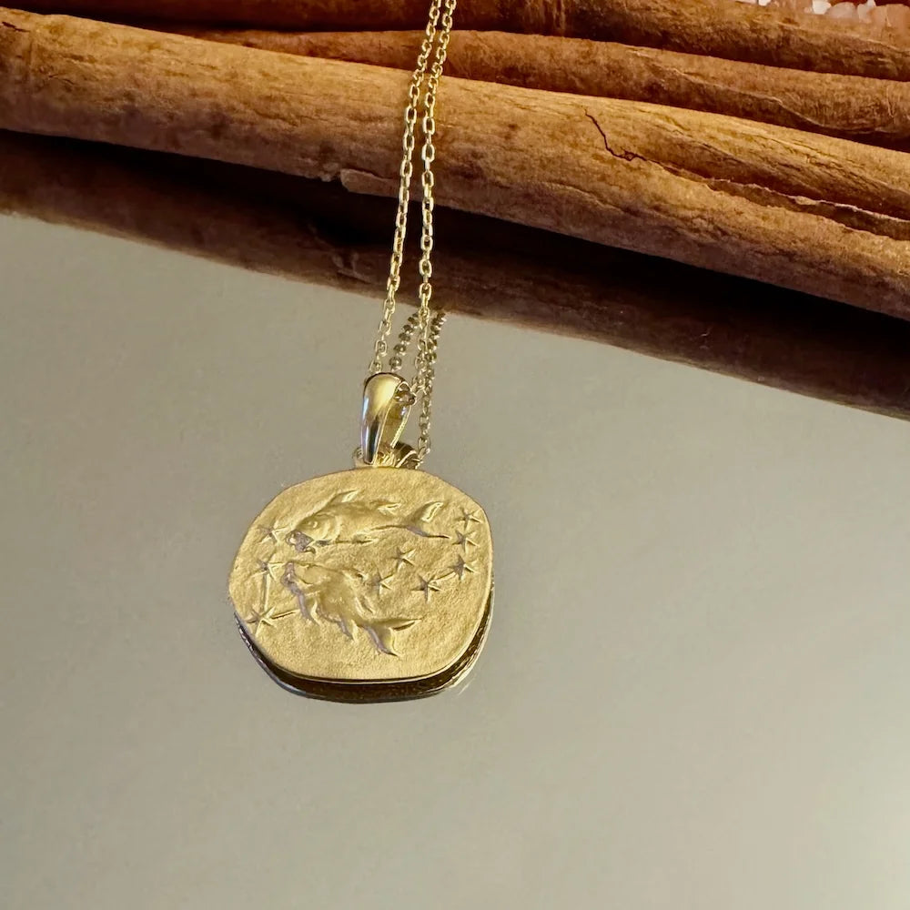 Gold pendant necklace with a unique celestial design, perfect for women seeking a chic, minimalist accessory.