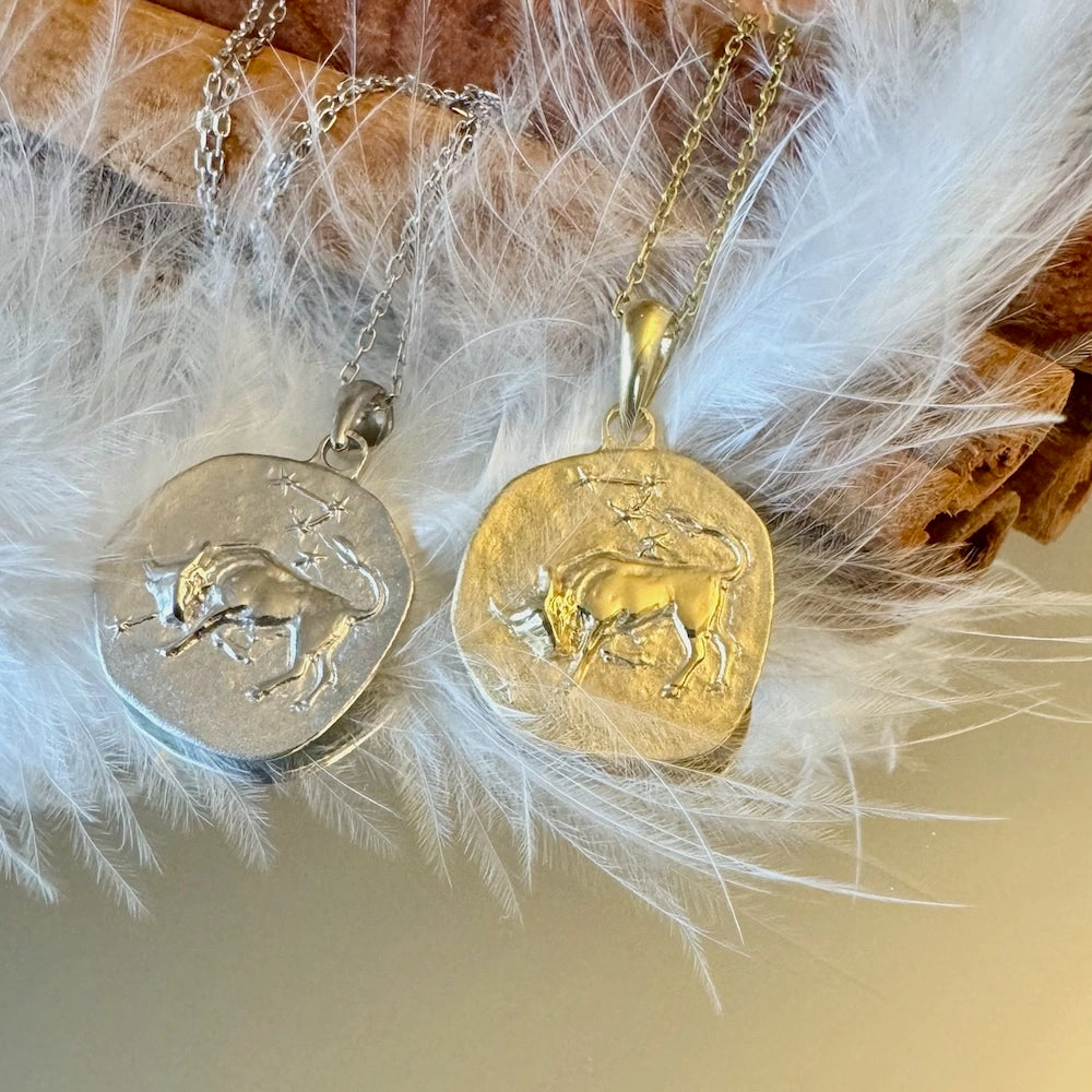 Silver and gold bull pendant necklaces embody zodiac charm, perfect for unique, unisex jewelry lovers. Ideal for casual wear.