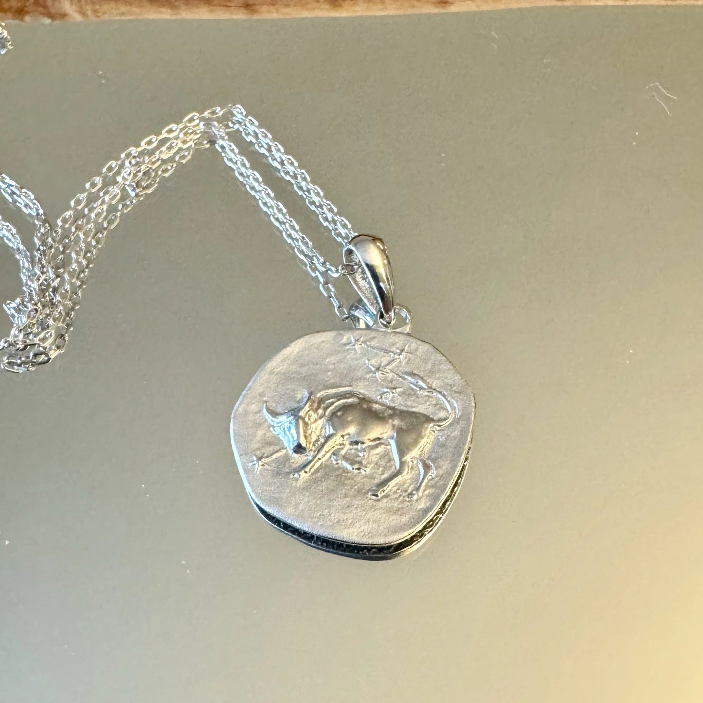 Silver bull pendant necklace, perfect for minimalist women who appreciate unique astrology-inspired jewelry.