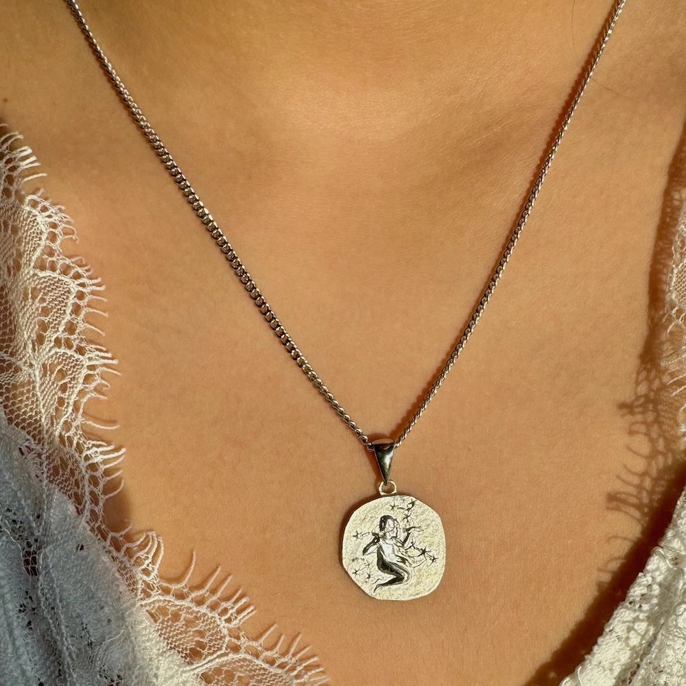 Silver pendant necklace featuring a detailed charm, perfect for women seeking vintage elegance for special occasions.