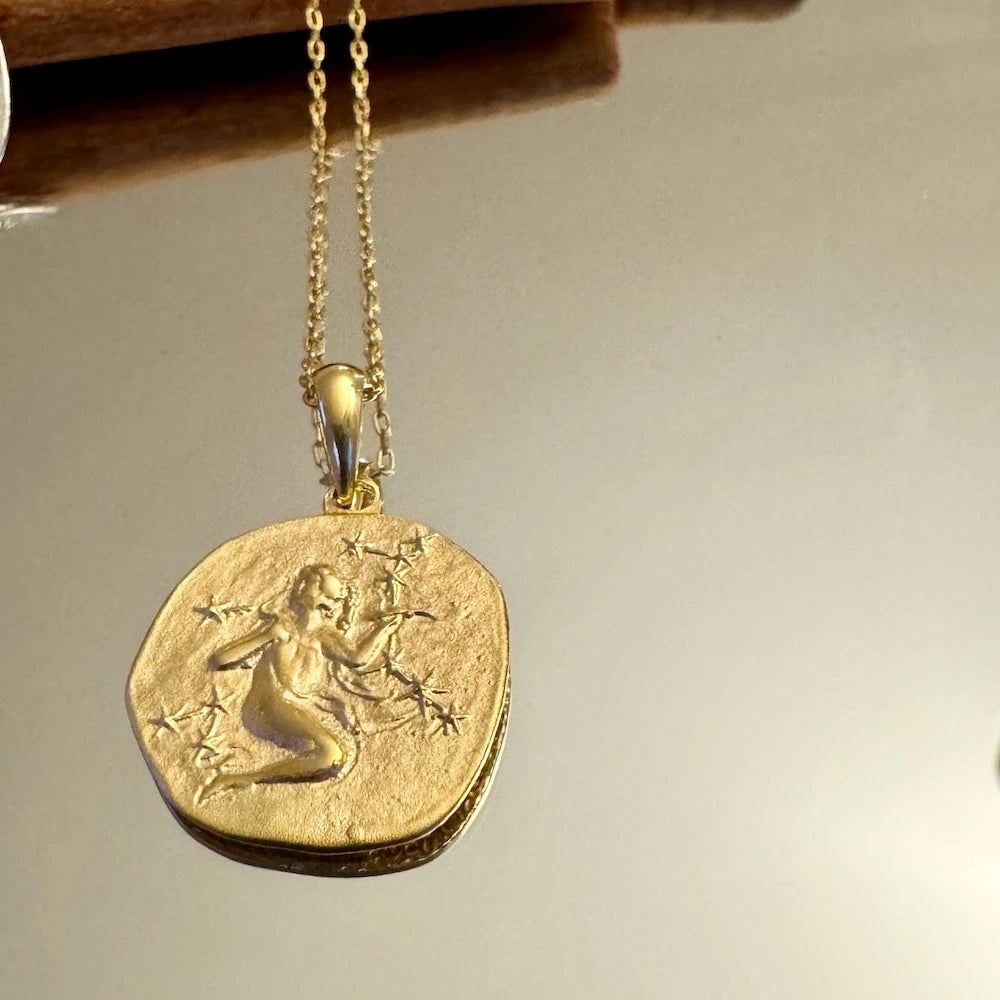 Gold pendant necklace featuring a vintage design, perfect for women seeking unique, bohemian jewelry.