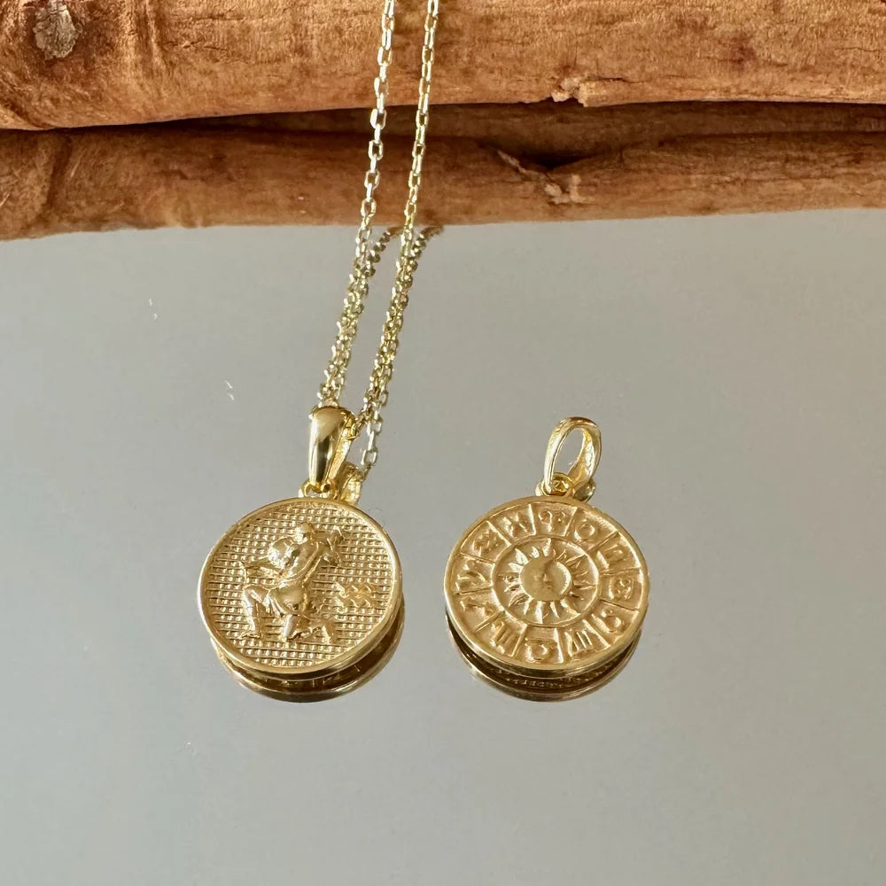 Gold pendant necklace featuring intricate zodiac designs, perfect for women seeking a classy, celestial accessory.