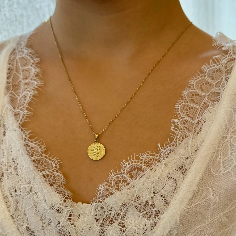 Delicate gold pendant necklace featuring a vintage coin design, perfect for women seeking a classic touch.