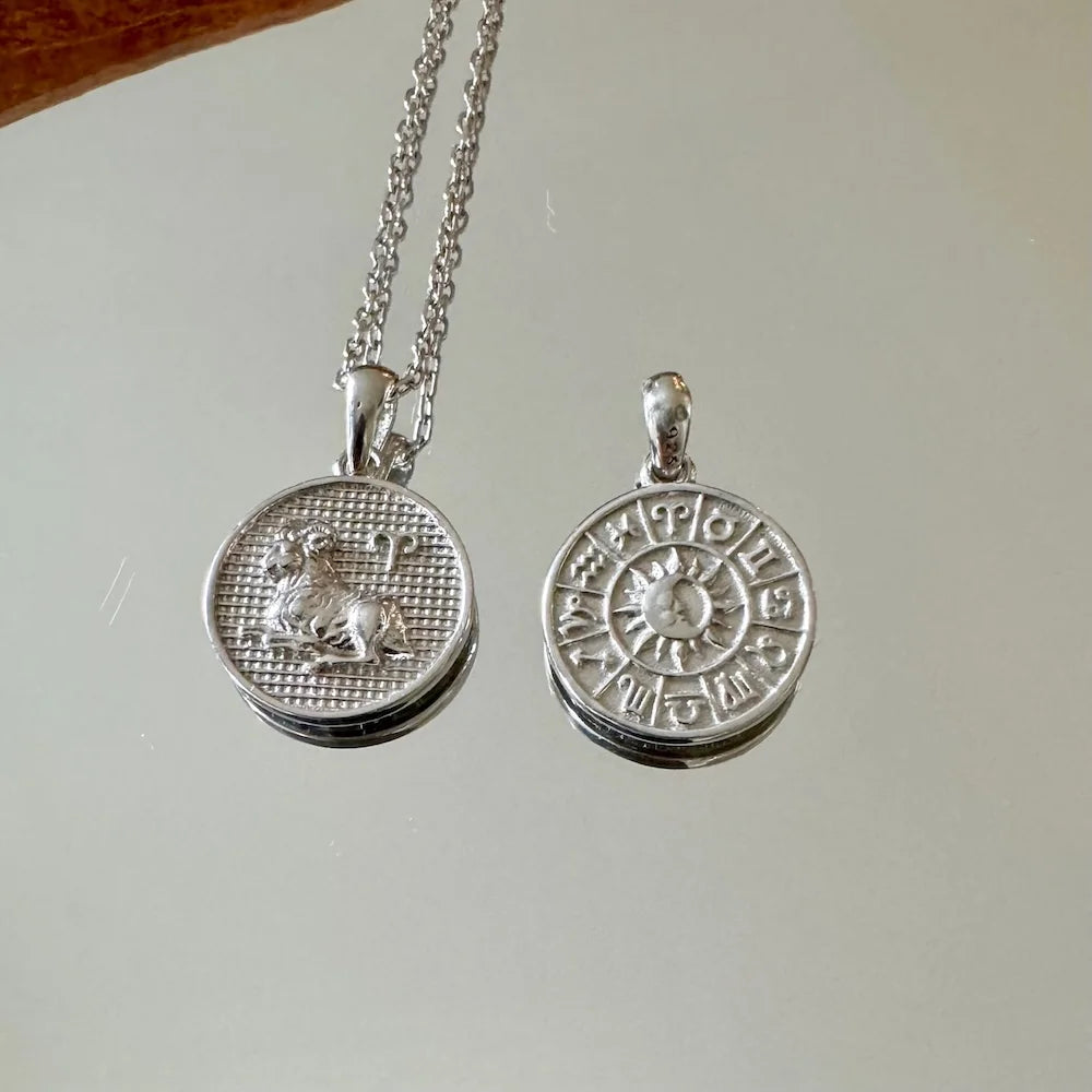 Sterling silver zodiac pendant necklace featuring intricate lion and astrological designs, perfect for astrology enthusiasts.