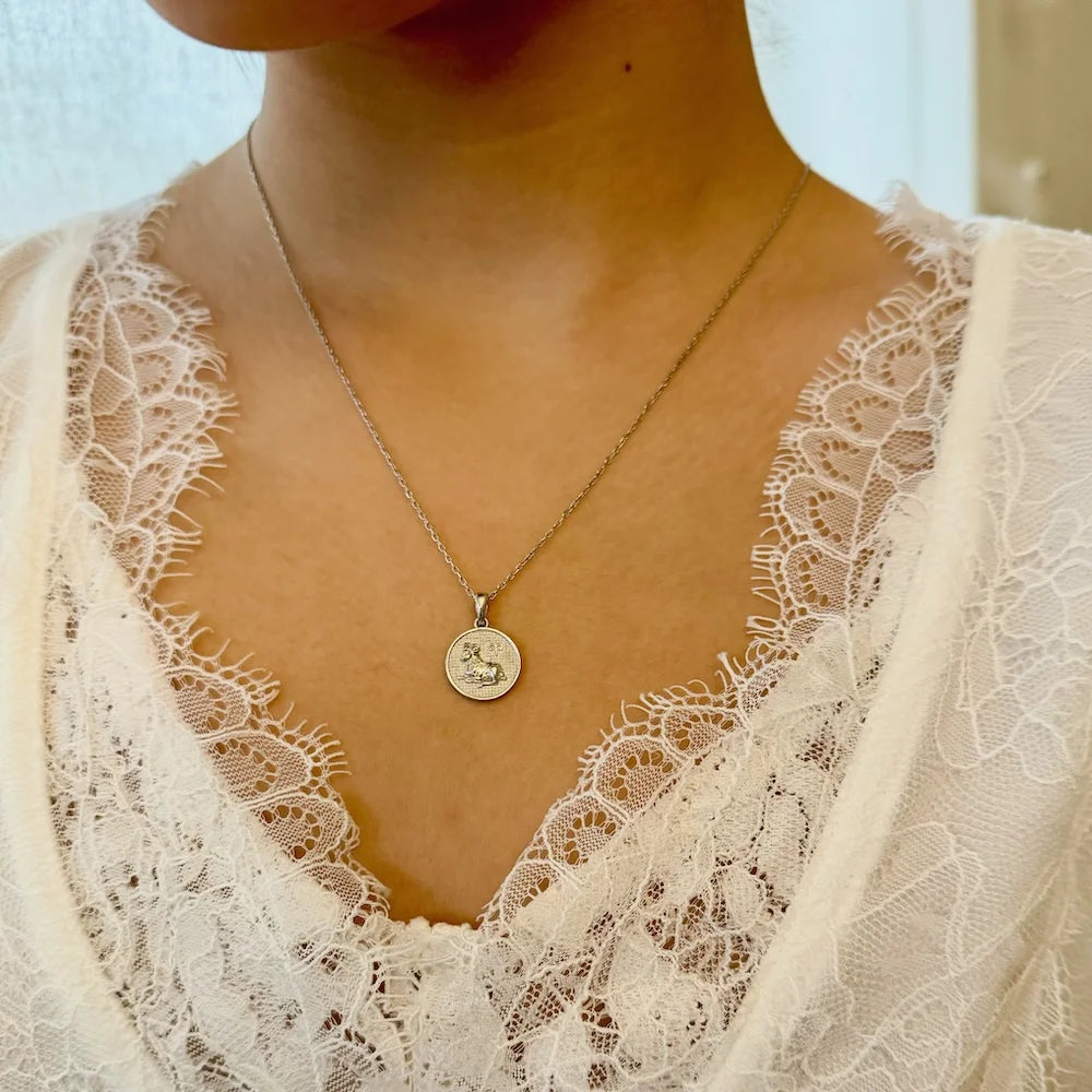 Silver coin pendant necklace on a woman, perfect for casual or vintage styles. A timeless gift for any occasion.