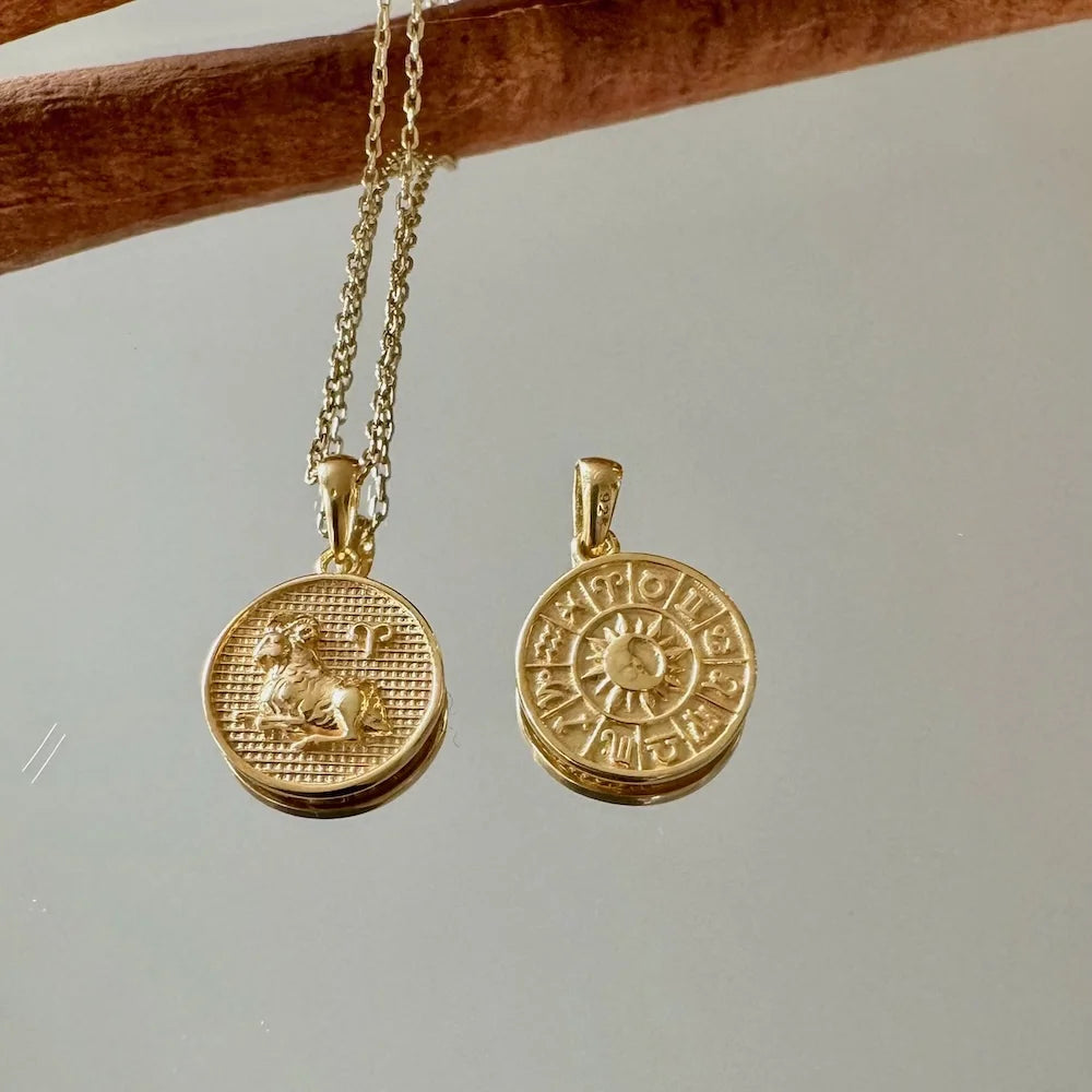 Gold zodiac sign necklace set with intricate designs, perfect for women seeking a unique, astrological touch.