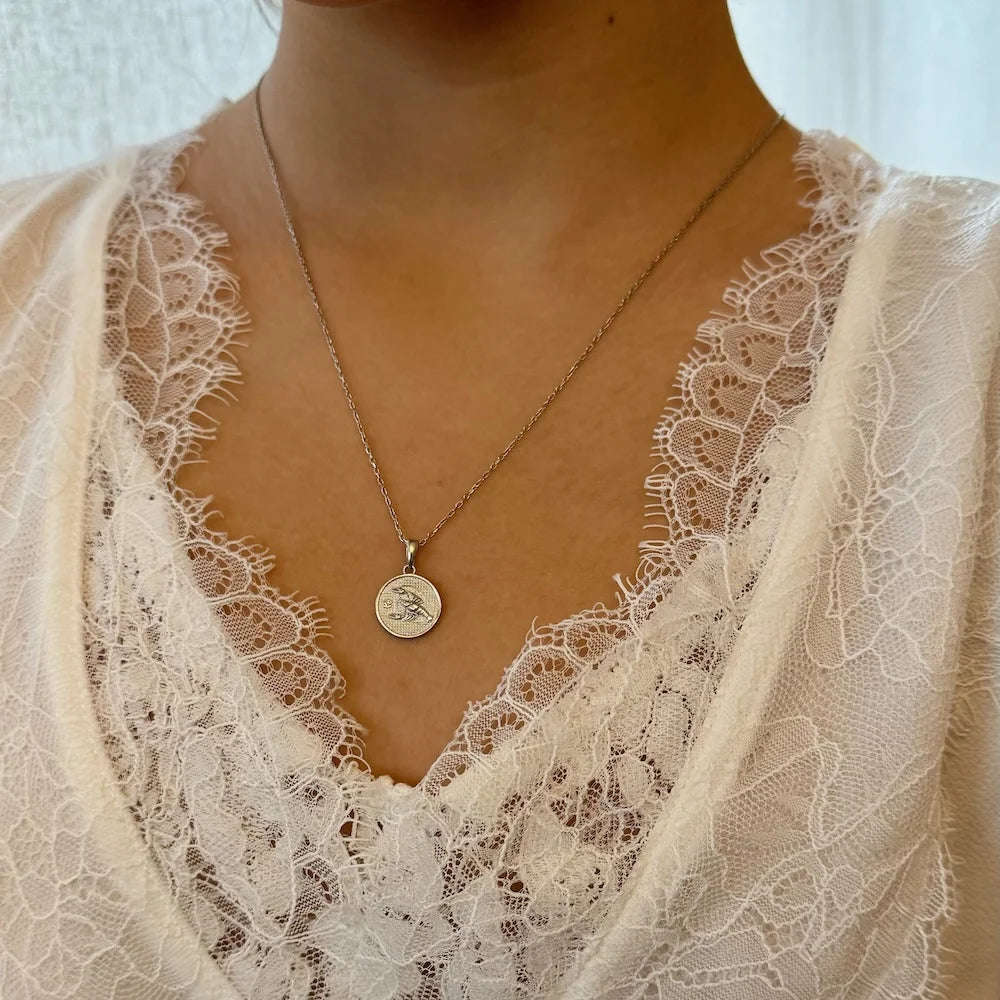 Delicate silver pendant necklace featuring a vintage coin design, perfect for women seeking a chic, minimalist accessory.